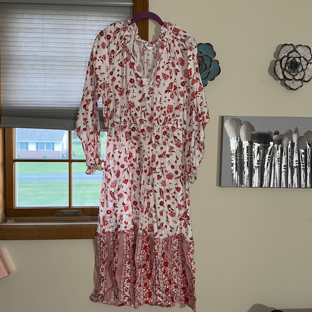 White dress with flower detail, lays right above ankles (I’m 5’2) long sleeve
